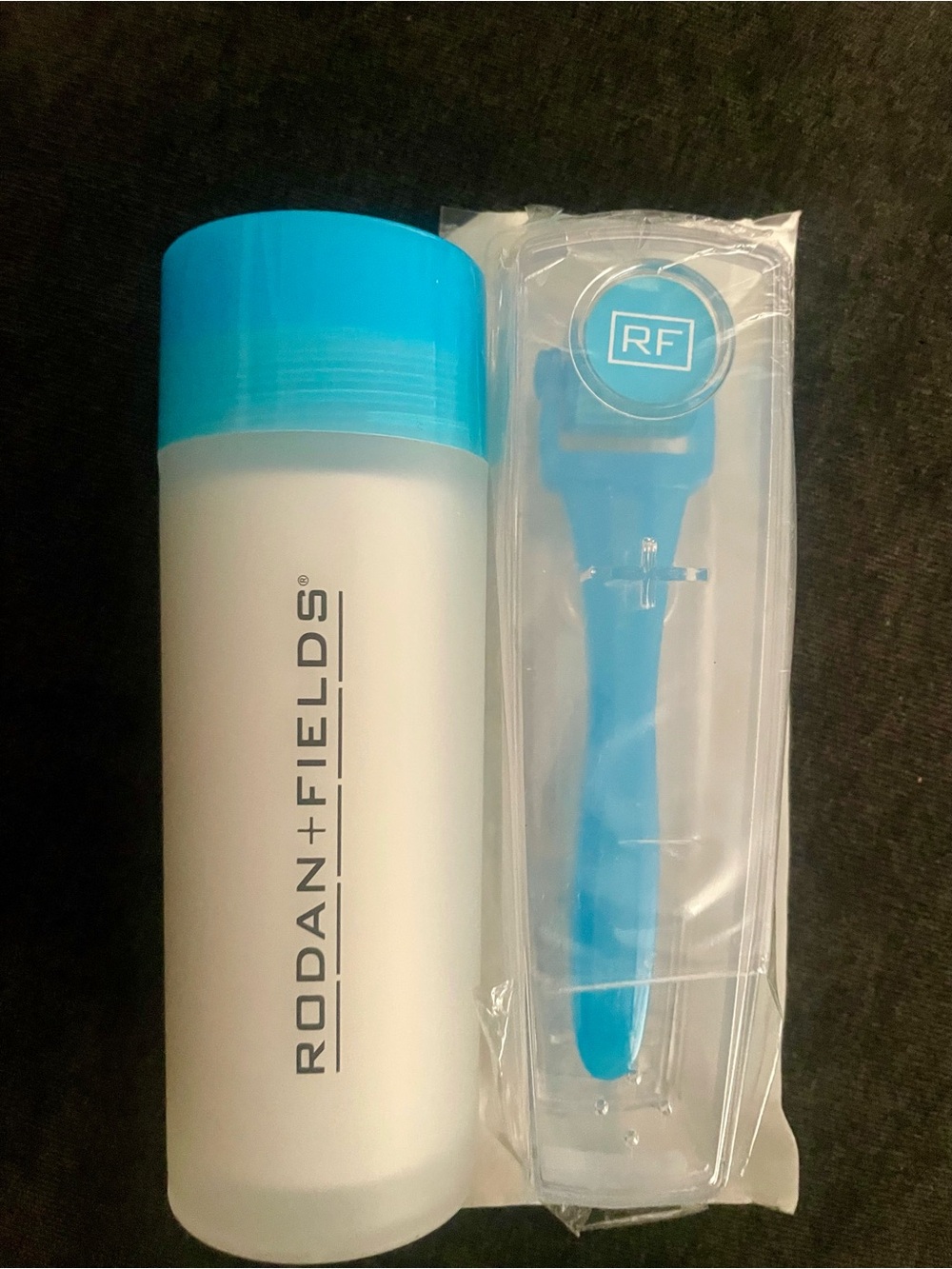 Rodan + Fields AMP MD Micro-exfoliating Roller and cleaning cylinder.